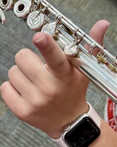 Left Hand should be in the shape of an L with the knuckle bump resting against the flute